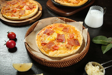 Homemade Italian Ham and Cheese Pizza with Fresh Ingredients on Rustic Wooden Table