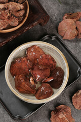 Soaked Dried Porcini Mushrooms in Bowl with Raw Ingredients for Asian Cuisine Cooking