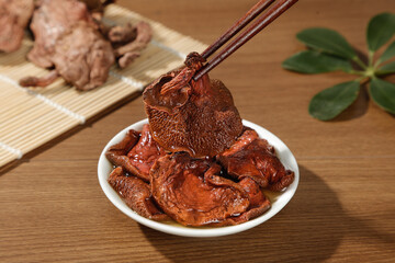 Yunnan Dried Red Porcini Mushrooms in Bowl with Chopsticks - Traditional Chinese Cooking Ingredients
