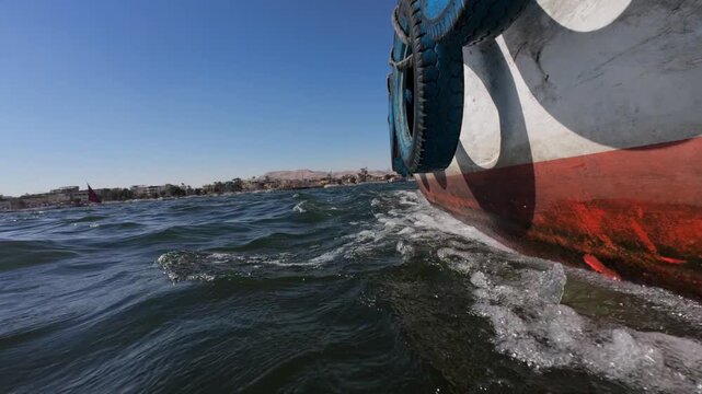 Tourist boat crossing Nile river in Luxor City on the way to Valley of Kings