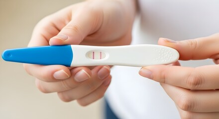 Positive Pregnancy Test A Close-Up View of a Woman's Hands Holding a Rapid Diagnostic Test Showing a Positive Result, Indicating Pregnancy