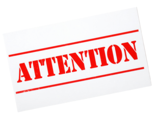 A bold sign displaying the word "ATTENTION" in red letters, emphasizing the importance of the message.