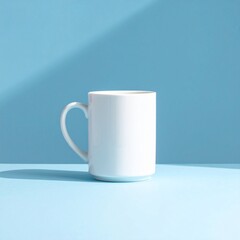 Obraz premium Minimalist still life of a blank white coffee cup on a light blue table, with a striking diagonal shadow creating a modern, clean aesthetic