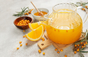 Warming sea buckthorn tea with orange slices and honey