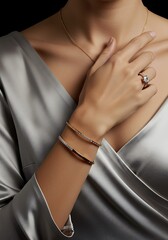 Elegant jewelry featuring a diamond ring and bracelets on a womans arm