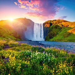 Majestic waterfall cascading into a vibrant flower-filled valley at sunrise