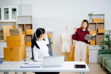 Starting small businesses SME owners, two check online orders Selling products working with boxs...