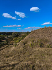 Hill with dry grass and blue sky