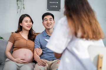 Asian young pregnant wife visit maternal health center with her husband.