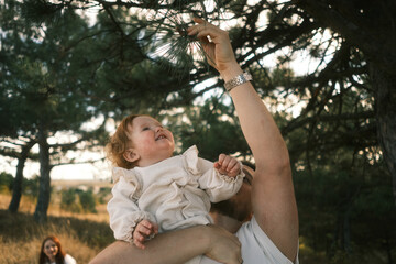A Joyful Child Reaching for Natures Beautiful Wonders and Exploring the Outdoors Together