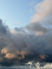 beautiful summer sunset with cumulus clouds turning orange.