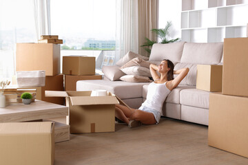 Happy woman moving house relaxing and resting