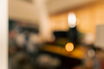 Cozy vintage desk setup featuring warm lighting, monitor, keyboard, gaming chair and gadgets in a studio workspace. Perfect background for productivity, lifestyle and workstation themes.