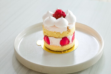 Delicious Strawberry Shortcake with Cream Topping Displayed on a White Plate