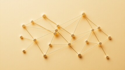 Network connections displayed with strings and nodes on a soft yellow background showcasing a conceptual design