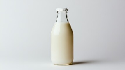 Fresh milk in a glass bottle on a plain background highlighting its creamy texture and simplicity