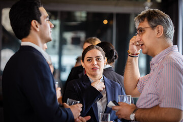Professional networking event with diverse colleagues sharing insights and building connections outside the office environment in a relaxed business atmosphere.