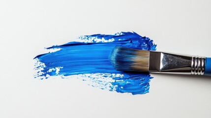 Brush strokes of vibrant blue paint on a blank canvas captured in an artistic workspace