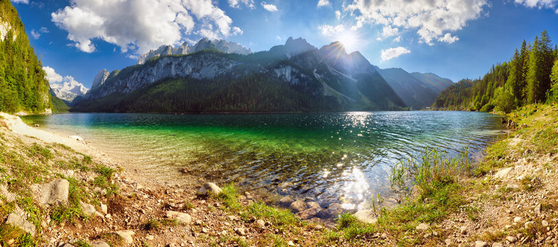 Peaceful scene of Vorderer ( Gosausee ) lake with Dachstein glacieron background. Picturesque evening view of Austrian Alps, Upper Austria, Europe. Traveling concept background.