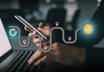 Digital Workflow Toward Goal Achievement and Success, Laptop and phone show winding path from target to trophy