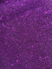 Purple glitter texture with rough sparkle and dynamic light play — festive, abstract, glamorous surface for design, fashion, or fantasy themes