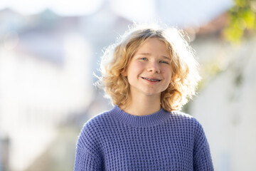 Young girl smiling with braces in natural light