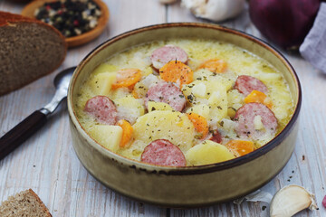 A bowl with traditional German potato soup with sausages	