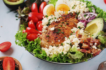 A bowl with cobb salad, traditional American dish