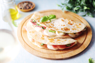 Traditional Italian dish Piadina romagnola - flat bread with mozarella and proscuitto