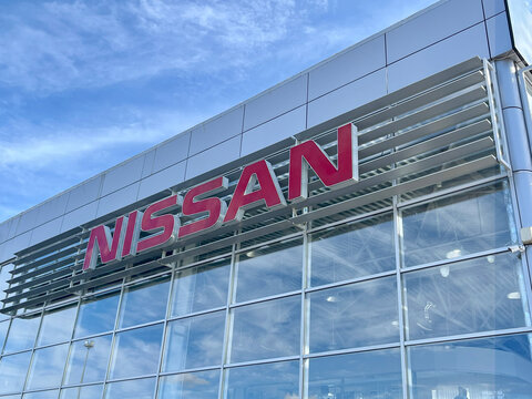 Simferopol, Crimea - September, 28, 2025: the exterior of a Nissan dealership. The building features modern design elements with a large prominent Nissan logo.