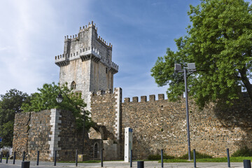 Medieval castle tower with stone wall and ramparts and fortification in Beja Portugal under blue...