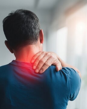A man with neck pain is holding his head and shoulder, back view of the person, red glowing aura on top left part on hand touching nape area