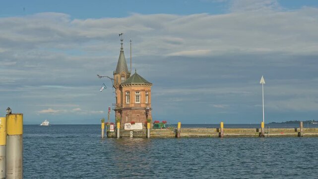 Small Lighthouse on old pier in harbor of Constance - Germany. Handheld and stabilized
