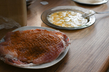 Pounded meat for pork chops, ready for breading.
