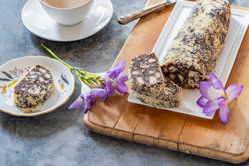 Fototapeta premium Sweet chocolate salami with nuts and biscuits