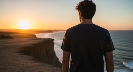 Young Man Standing on Cliff Edge Looking at Coastal Sunset View