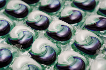 Close-up of laundry capsules. A modern and convenient means of clothing care, symbolizing cleanliness, efficiency and technological approach in everyday life.