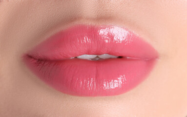 Obraz premium Woman with beautiful pink lipstick on her lips, macro view