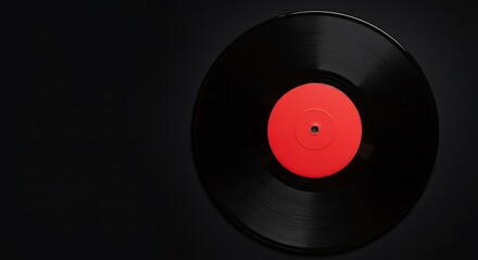 Close-up of a black vinyl record with a bright red center label on a dark background