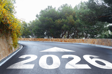 Road leads to 2026 with greenery alongside the winding path in a serene setting