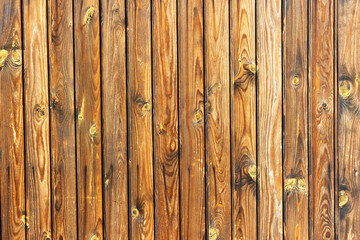 Closeup texture of wooden planks with natural grain, knots, and warm brown tones. Rustic wood background suitable for design, carpentry, construction, and decorative use