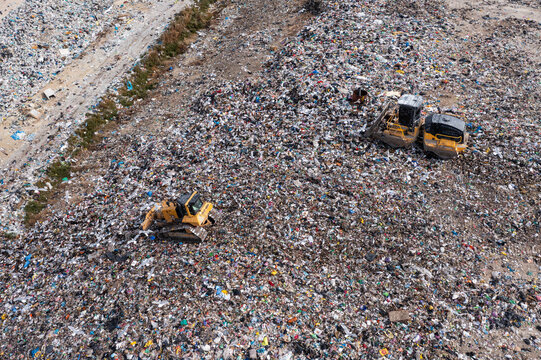 Arial view of excavator working with trash on rubbish dump