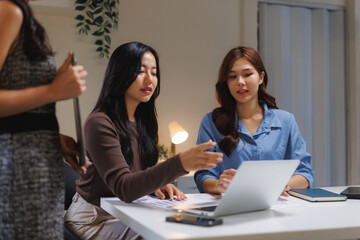 Business women discussing project ideas using laptop