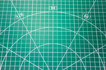 Workshop hand tools including tweezers, utility knife, scissors, and pliers placed on a craftsman’s cutting mat. Concept of DIY projects, handmade crafts, repair tools, and creative workshop supplies