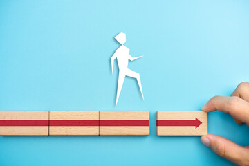Businessman hand connecting arrow on wooden cube with businessman icon