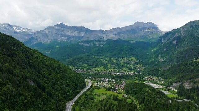 Aerial view circling the Servoz town, summer day in Haute-Savoie Alps, France