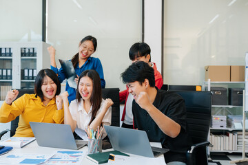 Fototapeta premium Startup asian business team collaborating in modern office, reviewing project strategy, sharing ideas, and building success through teamwork and planning.