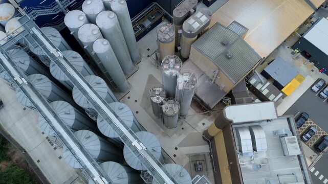 Top down aerial drone view of large industrial storage silos and flour milling factory producing and transporting goods in Eggborough England UK
