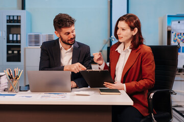 Business team working on a project in the office or reviewing and discussing a business project.