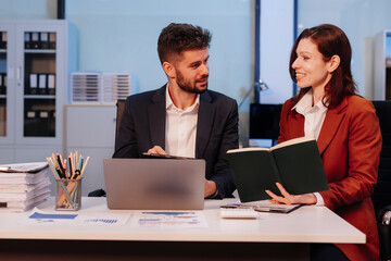 Business team working on a project in the office or reviewing and discussing a business project.